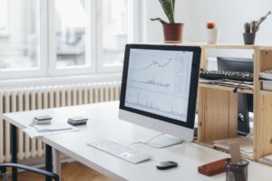 A comfortable workspace with modern equipment: a beautiful new table and a computer with white keyboard.